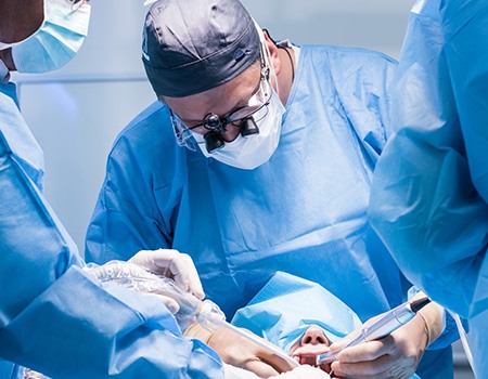 A male dentist performing a dental implant surgery