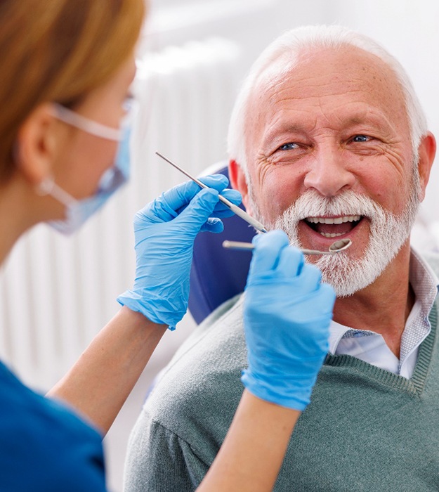 Man smiles at dentist