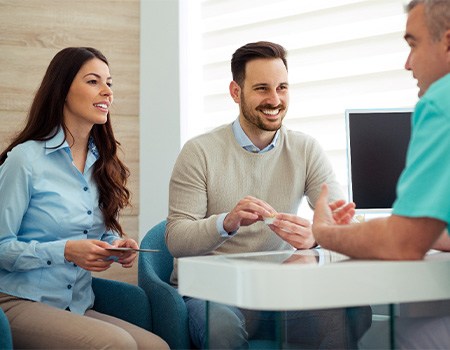 Dentist discusses matters with patients