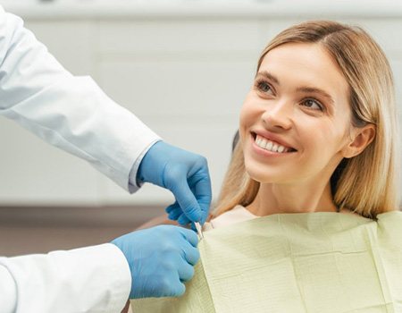 a patient smiling while visiting her dentist