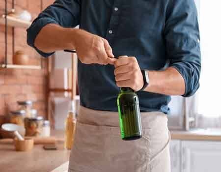 Man opens bottle with opener