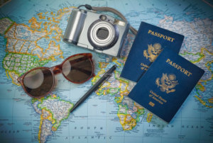 Passport and travel gear laid out on world map